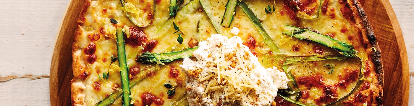 Asparagus and Ricotta Pizza served on wooden board